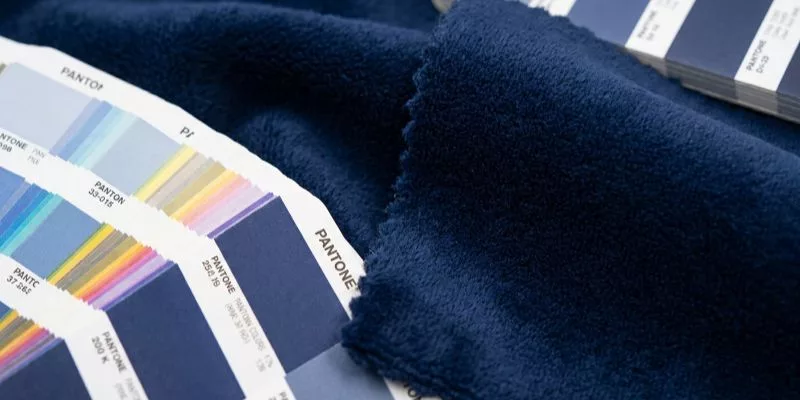 Fabric color matching for licensed character plush under D65 lighting with Pantone book