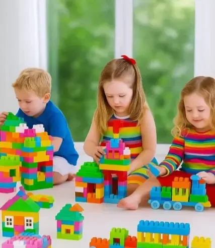 Children playing with magnetic building tiles in classroom