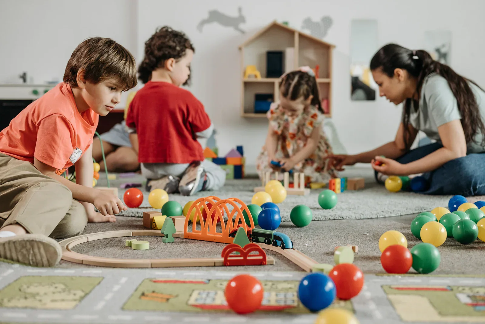 Children playing with colourful wooden and plastic educational toys